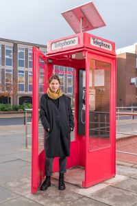 Image of Dr Sarah Jackson outside the poetry phone box.