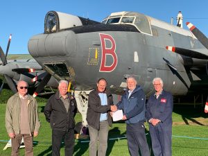 Representatives from the Newark Air Museum in front of the new planes they have acquired