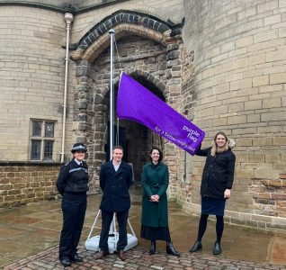 Purple flag being raised on a pole at Nottingham Castle