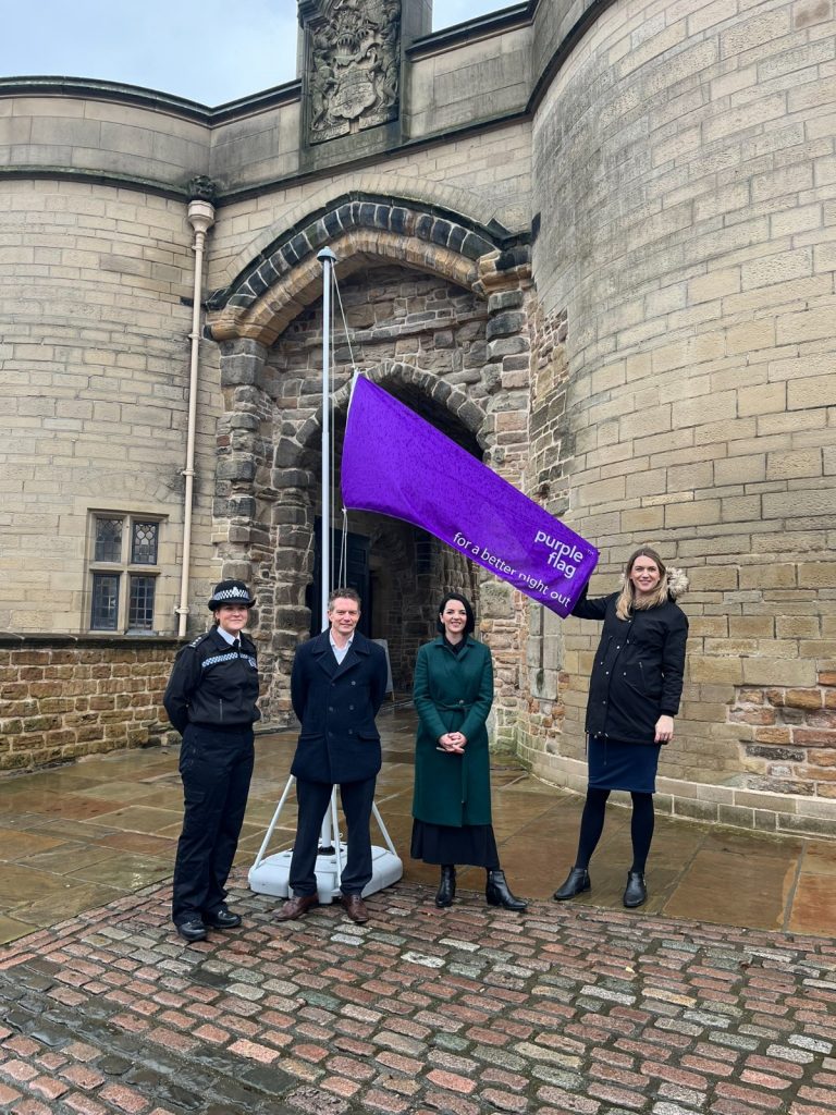 Purple flag being raised on a pole at Nottingham Castle