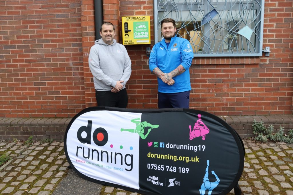 Des Oldham and Luke Court with the newly installed defib at the Portland Centre