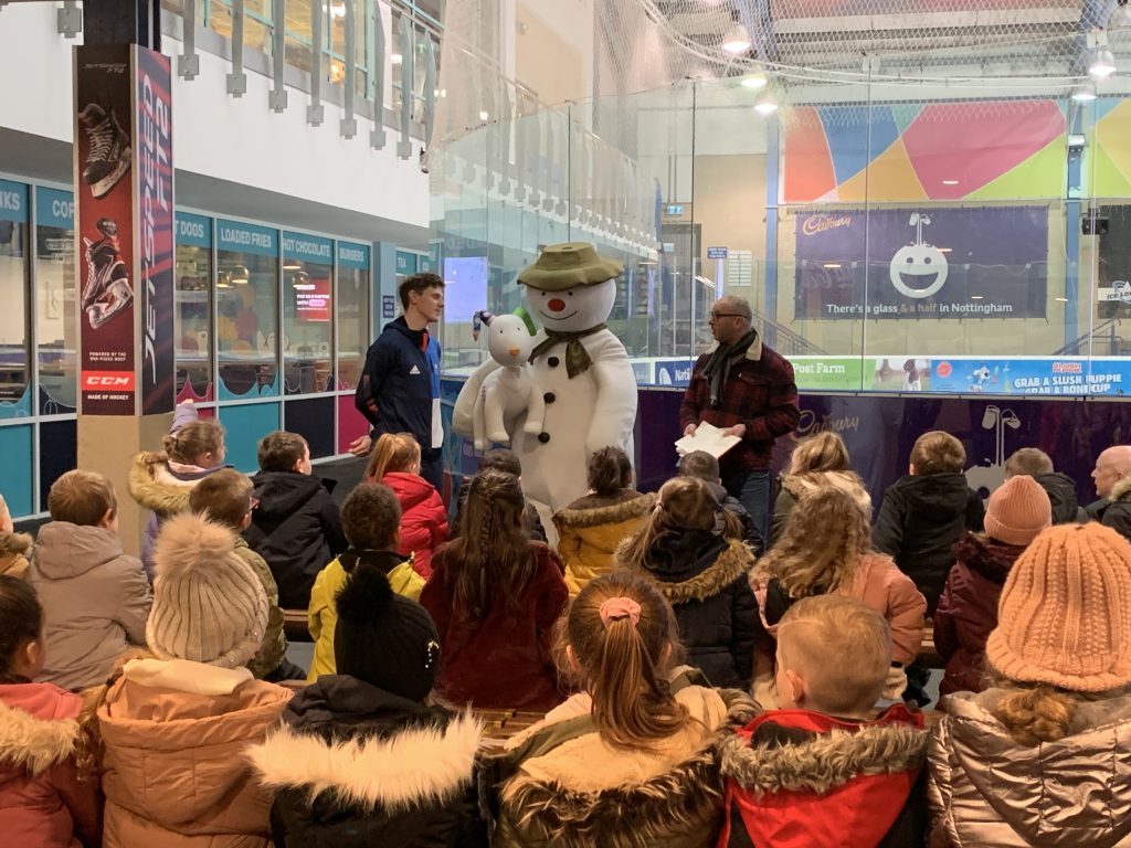 Children asking questions to the Snow Man, Snow Dog and Olympic skater