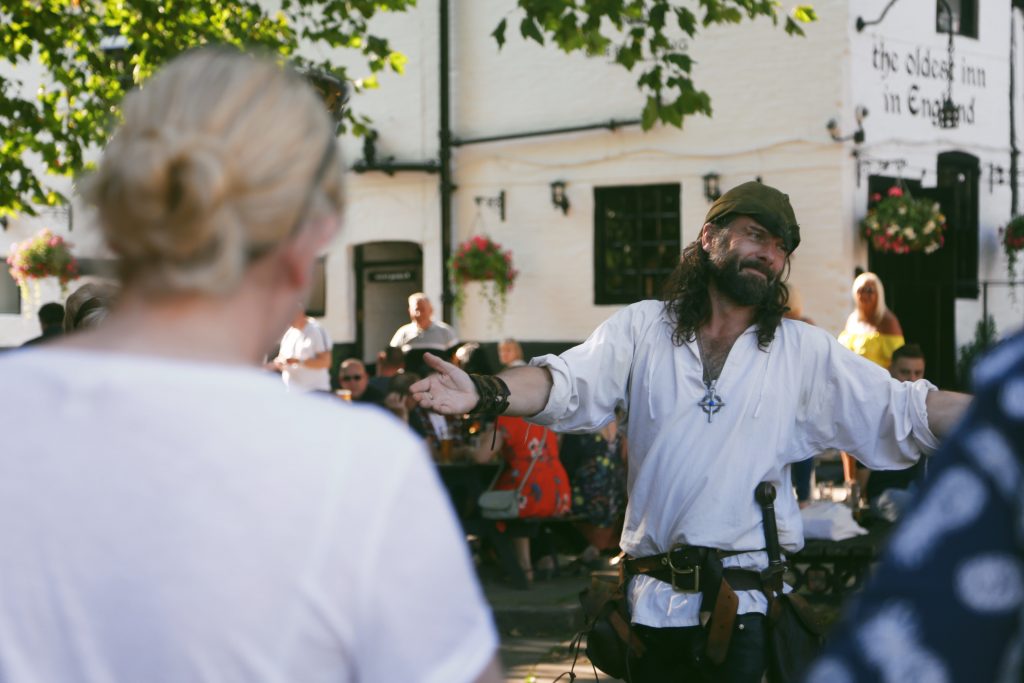 Robin Hood Stood outside the Ye Olde Trip to Jerusalem looking to the crowd with arms outstretched