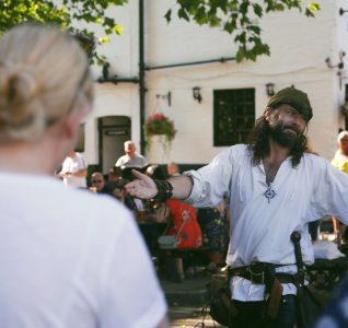 Robin Hood Stood outside the Ye Olde Trip to Jerusalem looking to the crowd with arms outstretched