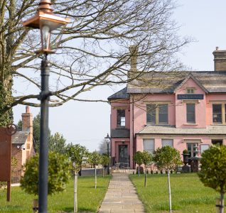 Picture of Vale house in the background with old street lamp in the foreground of the shot