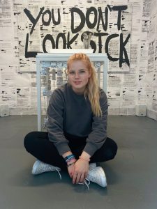 Artist Chloe with her work