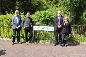 NTU academics stood at the sign for Lady Bay Roads