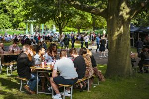 People sat enjoying the Arboretum beer festival
