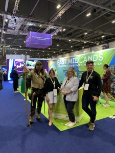 Robin Hood with Meet in Nottingham staff at the stand at the Meetings show 2022