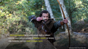 Robin Hood drawing his bow amongst the ferns in Sherwood Forest