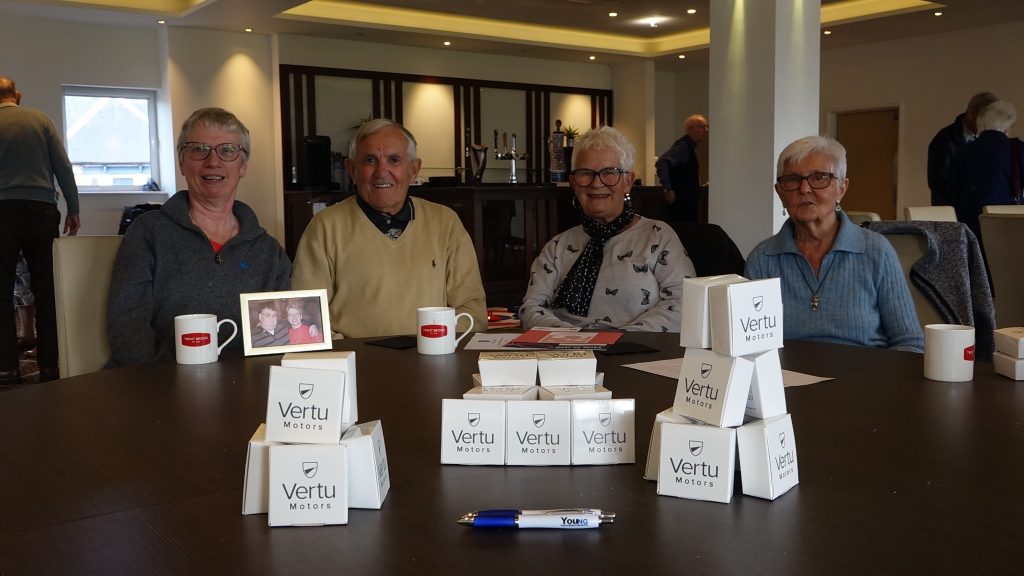 Participants at the Vertu Motors Day at Trent Bridge sat around the table smiling at the camera.