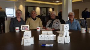 Participants at the Vertu Motors Day at Trent Bridge sat around the table smiling at the camera.