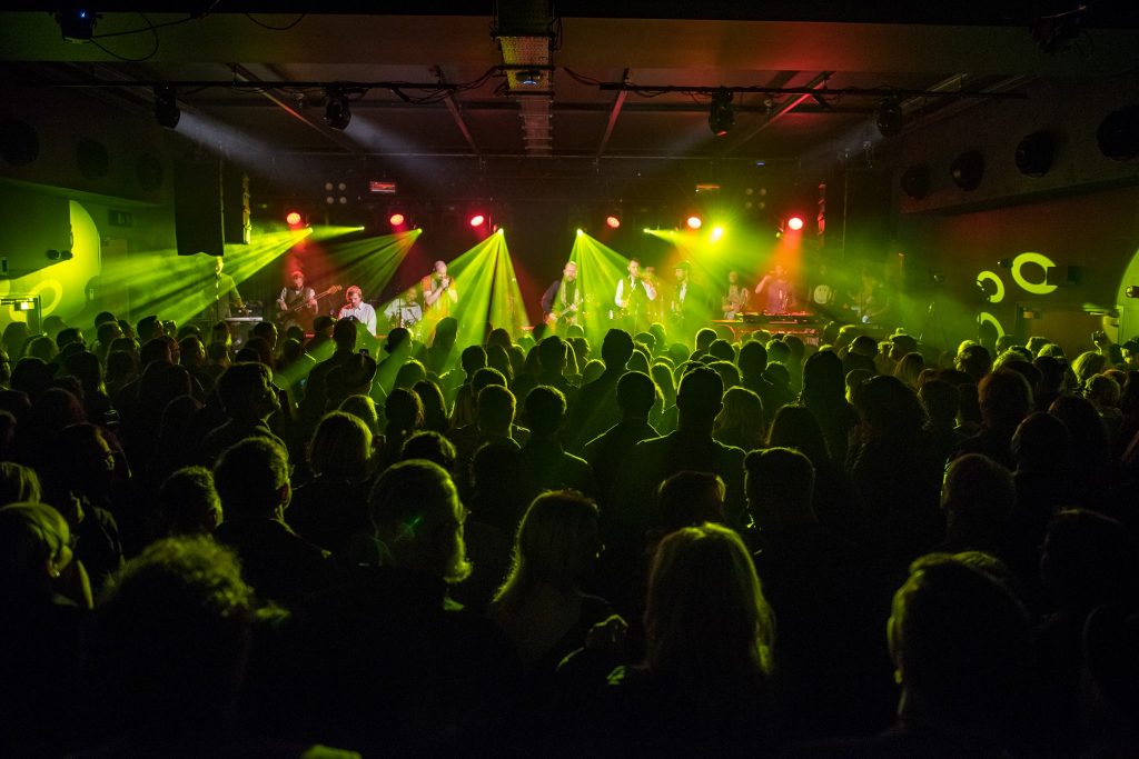 Crowd at Metronome in the evening with yellow lasers shooting out as part of the performance.