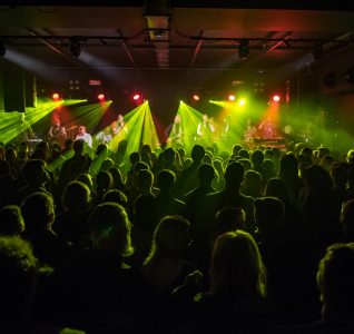 Crowd at Metronome in the evening with yellow lasers shooting out as part of the performance.