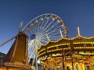 Windmill, big wheel and carousel all in the photo at winter wonderland