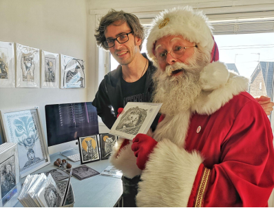 Santa Jolly with local artist Marcus with their artwork