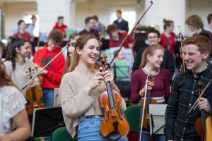 Members of the National Youth Orchestra sat with their instruments