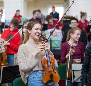 Members of the National Youth Orchestra sat with their instruments