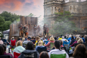 Actors on stage at an outdoor theatre at Wollaton Hall