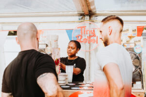 Someone pouring a beer at a previous arboretum beer festival.