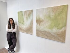 Young artist Anya Bell with her work at NTU
