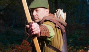 Robin Hood with his bow and arrow looking at the camera