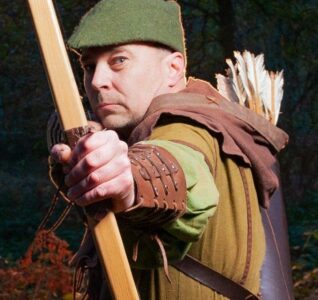 Robin Hood with his bow and arrow looking at the camera
