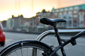 A picture of a bicycle seat on a bike which is chained up.