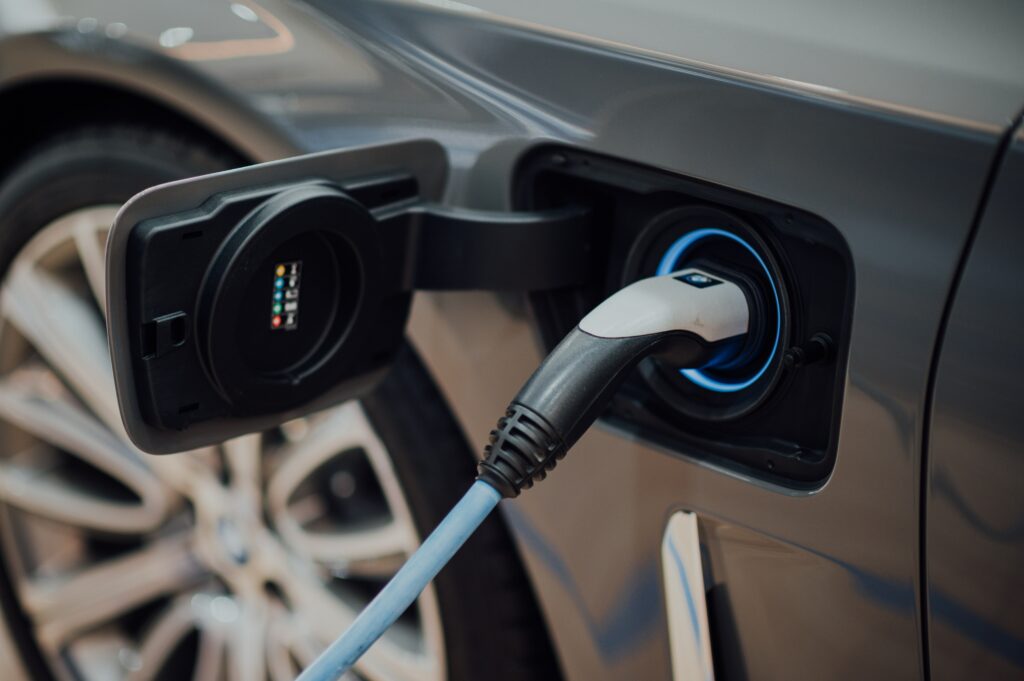 Shot of a recharging port on a electric car which is currently plugged in and charging.