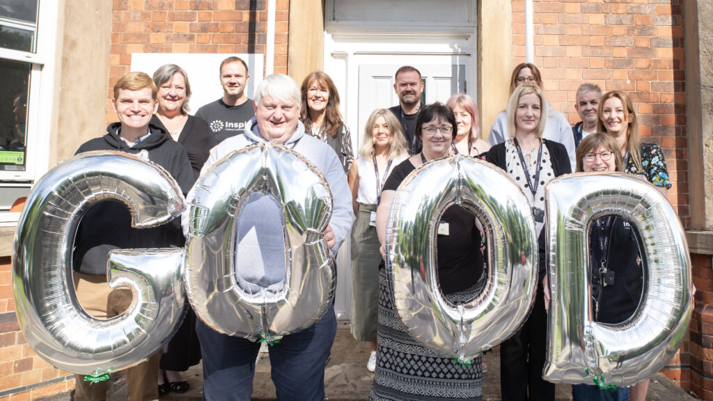 Library workers stood outside one of their learning centres with balloons spelling out the word 'good'.