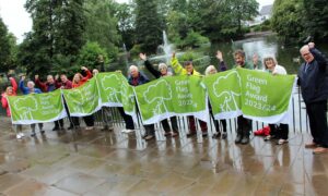 Gedling council officers with some green flags in one of the borough's parks