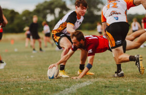 Man diving to score a try in touch rugby.
