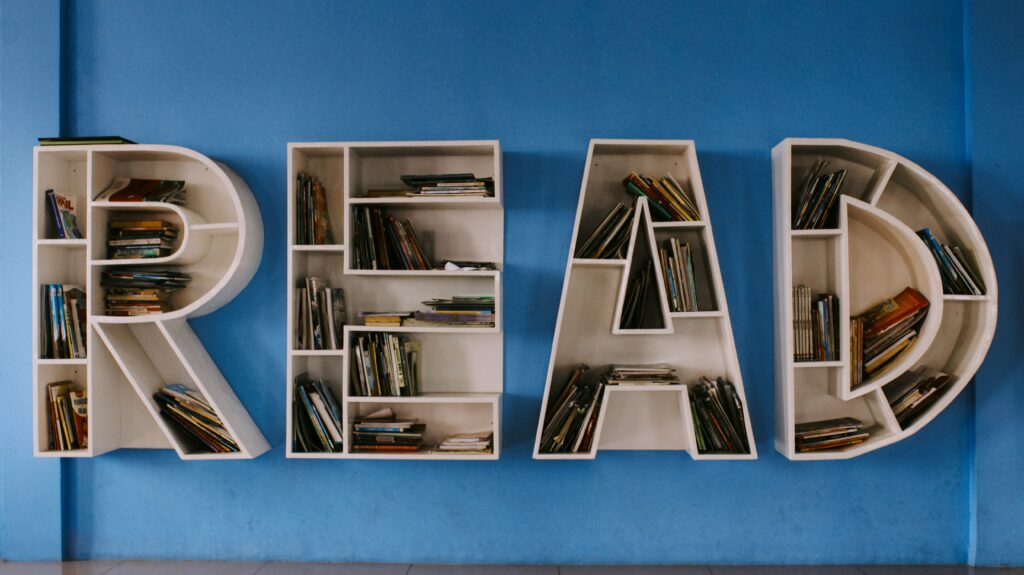 book shelves spelling out the word read on a wall