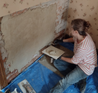 A volunteer carrying out plasterwork at the D.H. Lawrence Birthplace Museum