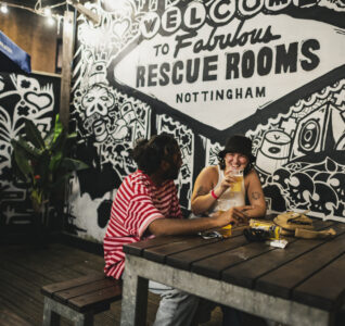 A photo of two people enjoying a drink at DHP's Rescue Rooms venue