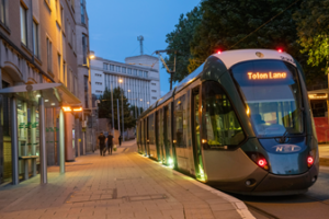 Tram in Nottingham at dusk headed for Totten Lane.