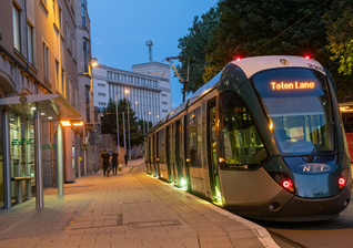 Tram in Nottingham at dusk headed for Totten Lane.