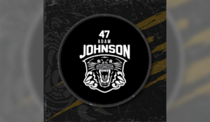 Image of the puck for Adam Johnson which has his name on it as well as the Nottingham Panthers Logo