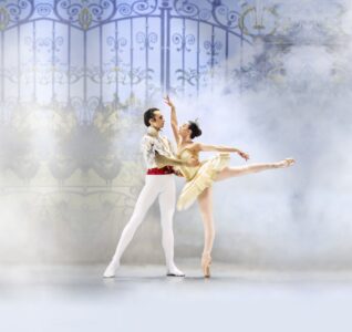 Two ballet dancers in swan lake holding one another.
