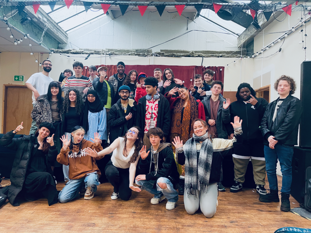 Group of young people in a hall together smiling for the camera