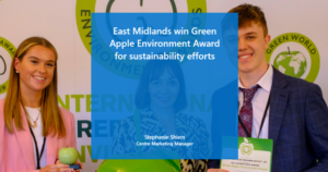 Photo of three people accepting the green apple award