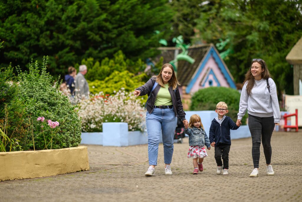 Two ladies with a young boy and girl holding their hands whilst at Sundown Adventure Land