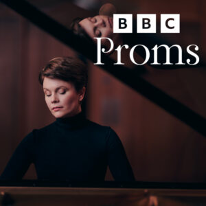 Image shows the BBC Proms logo in the top right corner and a woman in the middle of the image looking down.