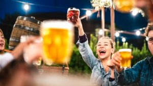 This image shows a girl holding up a beer at FrulingFest at Binks Yard