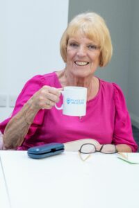places-of-welcome-Mansfield-library-POW-people-sat-at-table-smiling-community-makers-volunteer