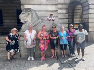 Photo of Travel Well participants in front of a lion statue at Nottingham Council House