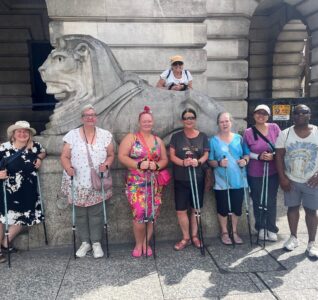 Photo of Travel Well participants in front of a lion statue at Nottingham Council House