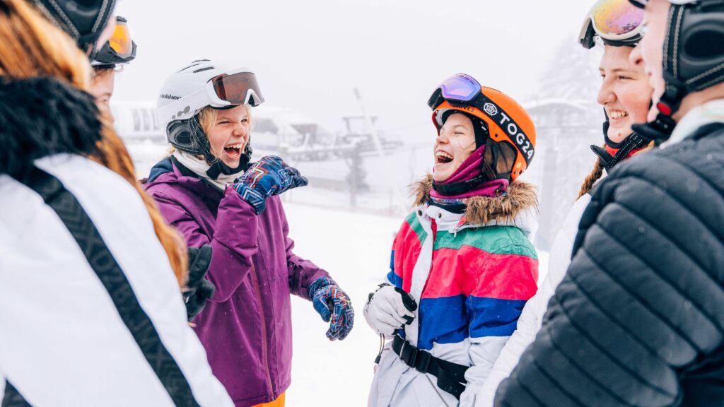 children in the snow and ski
